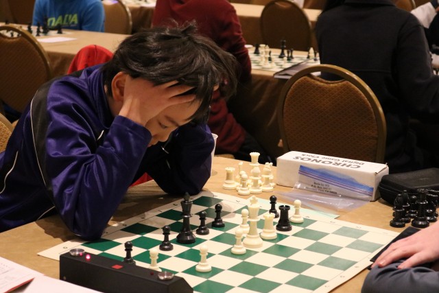 Max Lu, fighting for a win on the top board during the last round