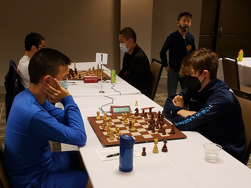 FM Nico Chasin (right) waits on IM Jason Liang to make his next move at the 2022 U.S. Cadet. Photo: Micheline Wilson