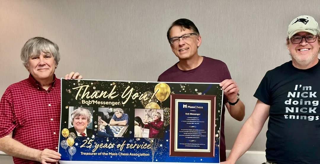 Messenger (L) with MassChess President Michael Urbonas and Clerk Dr. Nick Sterling with a poster created by Board Director Elsie Smits.