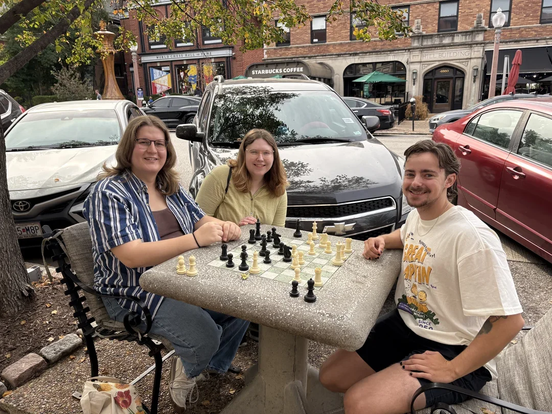 Passers-by Heather, Amelia, and Levi were drawn in by the chess tables and thrilled to learn the U.S. Championships were underway.