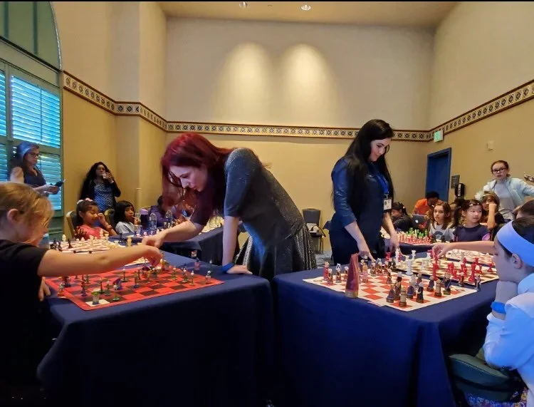 Jen Shahade and Carolina Blanco give a simul at the K-12 Nationals in Orlando, Florida