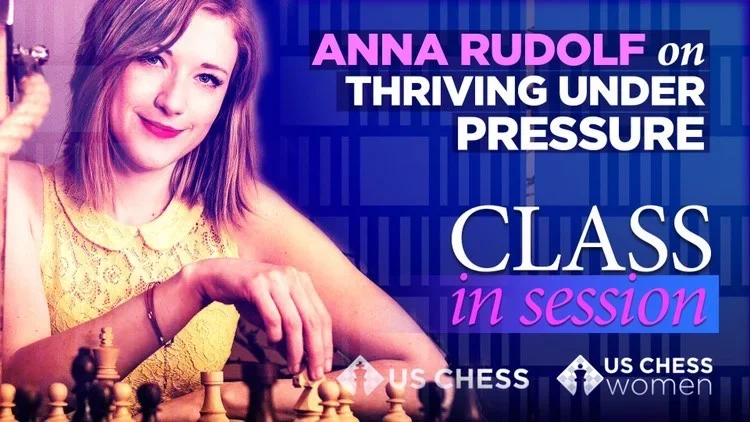 Anna Rudolf, an International Master, holding a chess piece