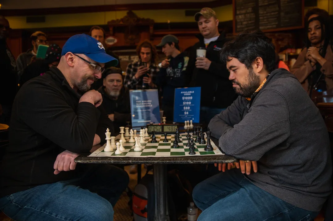 Chess Life editor John Hartmann grimaces when he realizes he’s already lost in this New Orleans blitz game. (Photo by James Cullen)