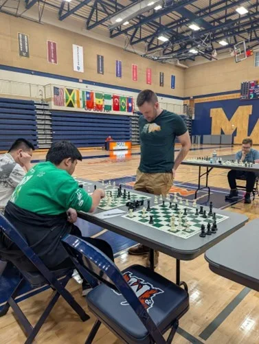 Caption: IM Bartholomew deciding what to play against Hua (Photo courtesy of Johnny Harbieh)