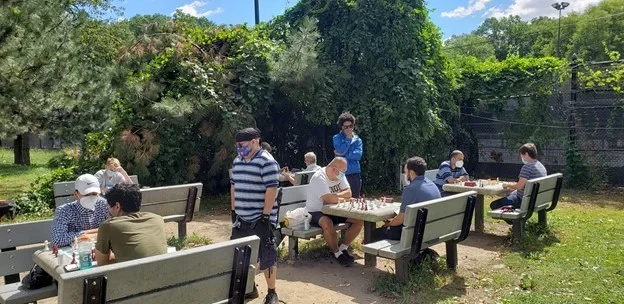 Players enjoy chess outdoors at Cunningham Park in Queens.