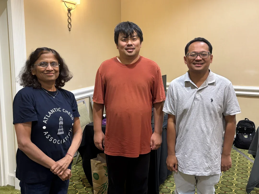 Blitz winner Jianchao Zhou (center) and runner-up Mark Paragua.