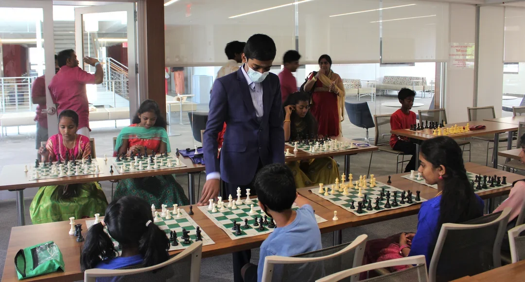 GM Rameshbabu “Pragg” Praggnanandhaa playing a simul at St. John's in New York City. Photo: Jay Kleinman