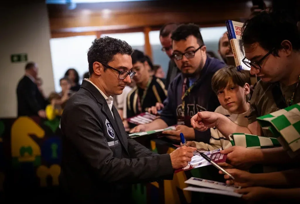 Caruana signing autographs