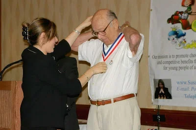 That’s me presenting the Polgar medal to GM Arnold Denker at the first annual Susan Polgar National Invitational for Girls