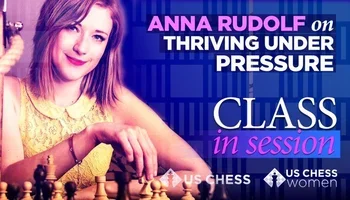 Anna Rudolf, an International Master, holding a chess piece 