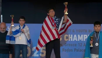 Ethan Guo holding his first-place trophy 
