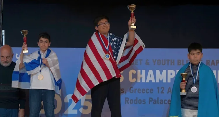 Ethan Guo holding his first-place trophy 