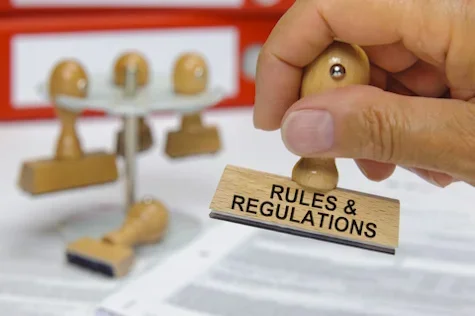 Pawn-shaped stamp labeled "Rules & Regulations"
