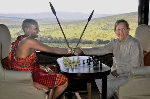 Karipoi and Dewain Barber playing chess on the African plain