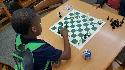 Photograph: middle school students playing chess