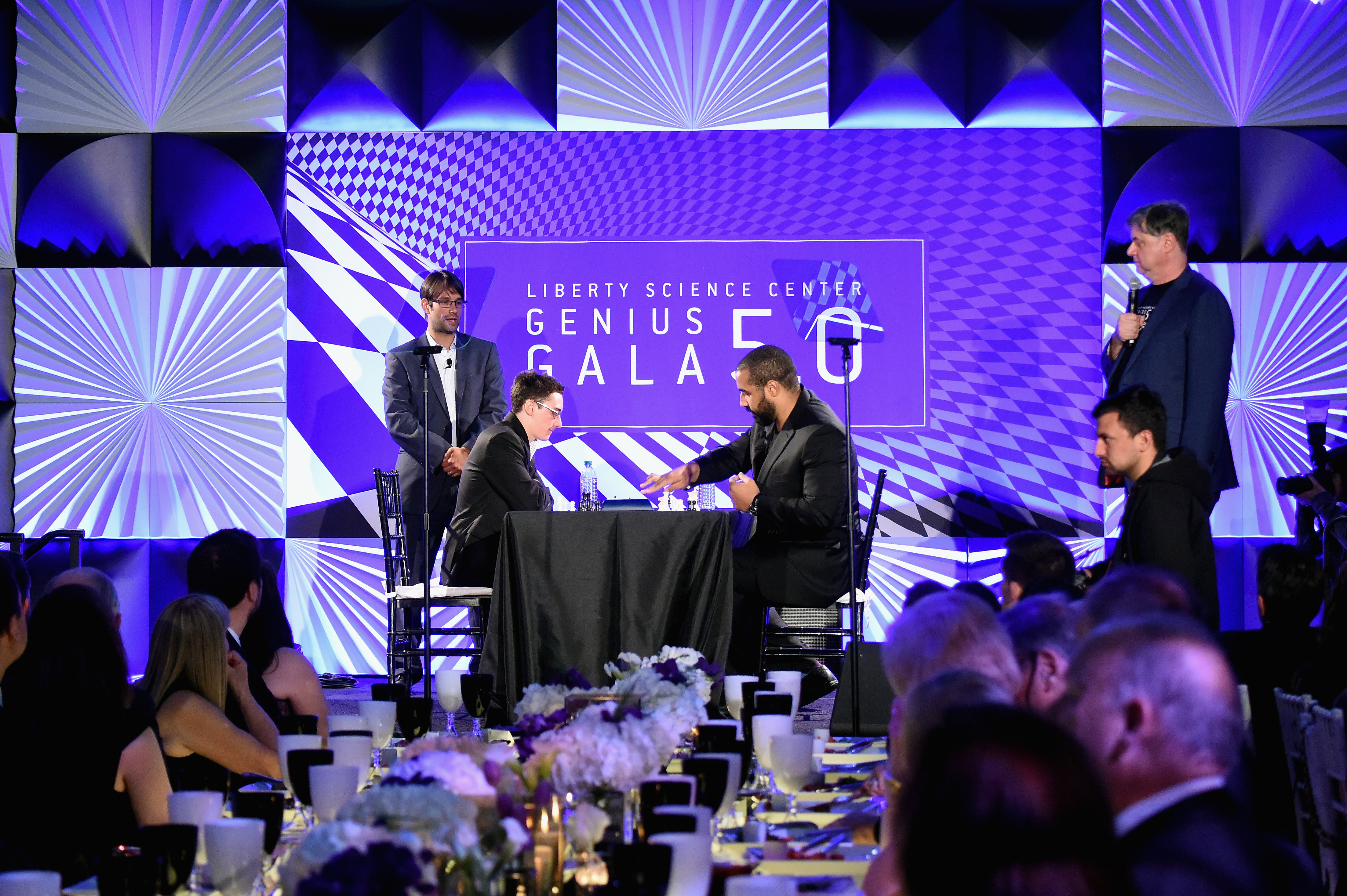 "JERSEY CITY, NJ - MAY 20: US National Chess Champion, Fabiano Caruana, (L), plays NFL Raven and mathematician, John Urschel, challenge eachother in a game of chess onstage at the Liberty Science Center's Genius Gala 5.0 on May 20, 2016 in Jersey City, New Jersey. (Photo by Mike Coppola/Getty Images for Liberty Science Center)"